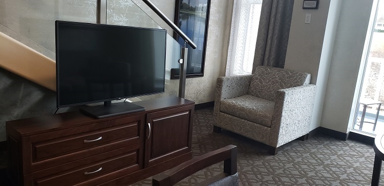 The Loft Suites on American Duchess have a living area with a large credenza and flat-screen TV.