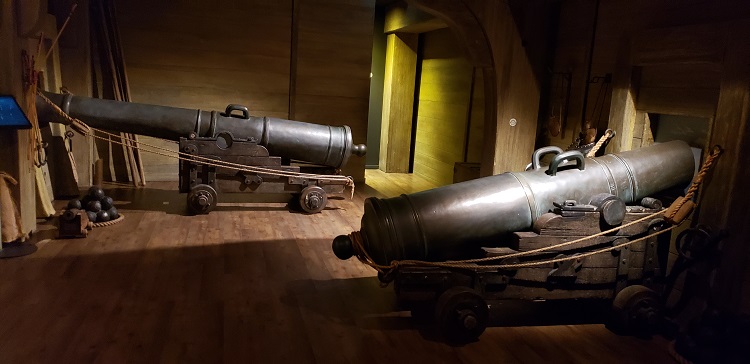 Cannons are shown within a ship at the World of Discoveries. Photo by Susan J. Young