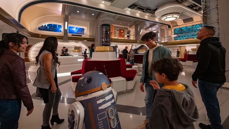 Astromech droid SK-62O greets guests in the Atrium of the Halcyon starcruiser in Star Wars: Galactic Starcruiser at Walt Disney World Resort in Lake Buena Vista, Fla. (Matt Stroshane, photographer)