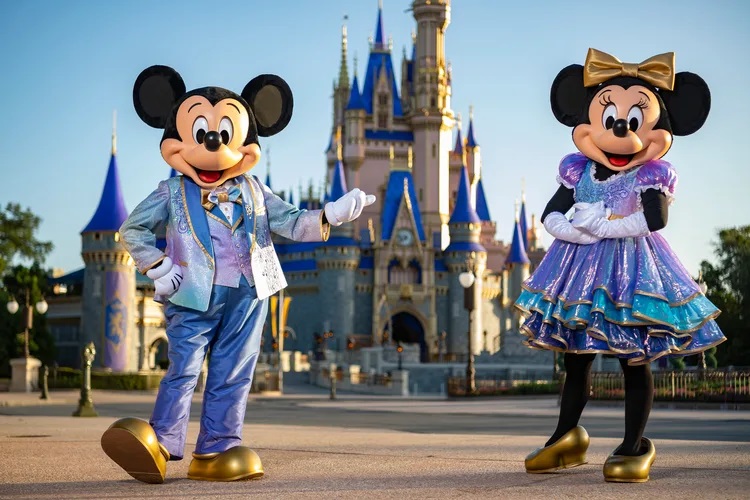 ickey Mouse and Minnie Mouse will host “The World’s Most Magical Celebration” honoring Walt Disney World Resort’s 50th anniversary in Lake Buena Vista, Fla. They will dress in sparkling new looks custom made for the 18-month event, highlighted by embroidered impressions of Cinderella Castle on multi-toned, EARidescent fabric punctuated with pops of gold. (Matt Stroshane, photographer)