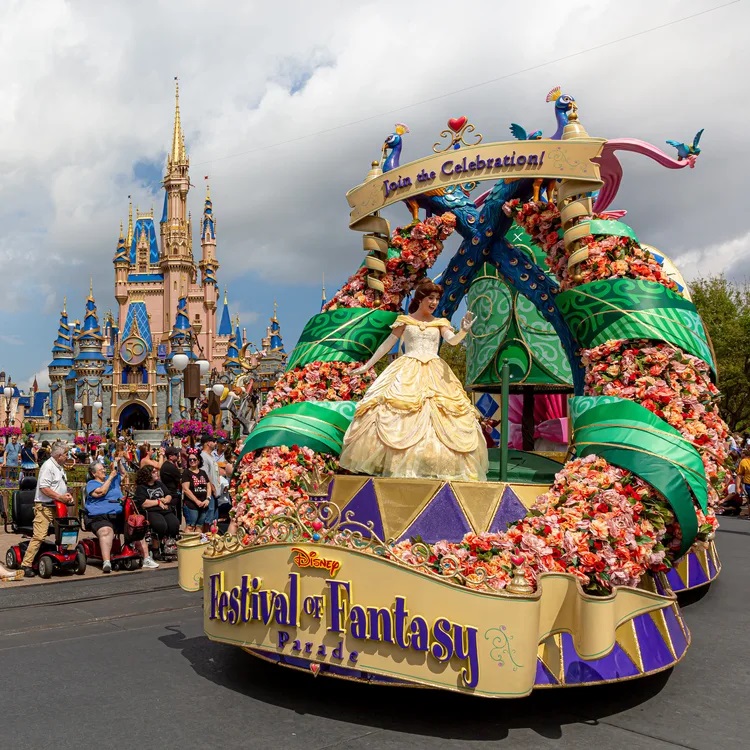 Belle waves to guests during the “Disney Festival of Fantasy Parade” in Magic Kingdom Park at Walt Disney World Resort in Lake Buena Vista, Fla. The parade returned to the park Wednesday, March 9, 2022, after a nearly two-year absence. (Courtney Kiefer, photographer)