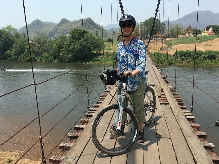 Heidi Sarna, author, editor and travel journalist, loves to dive deeply into a destination via cycling. Here she's shown in Thailand. Photo courtesy of Heidi Sarna.