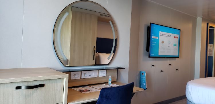 Desk area and large flat-screen TV in #7308, Wonder of the Seas. Photo by Susan J. Young