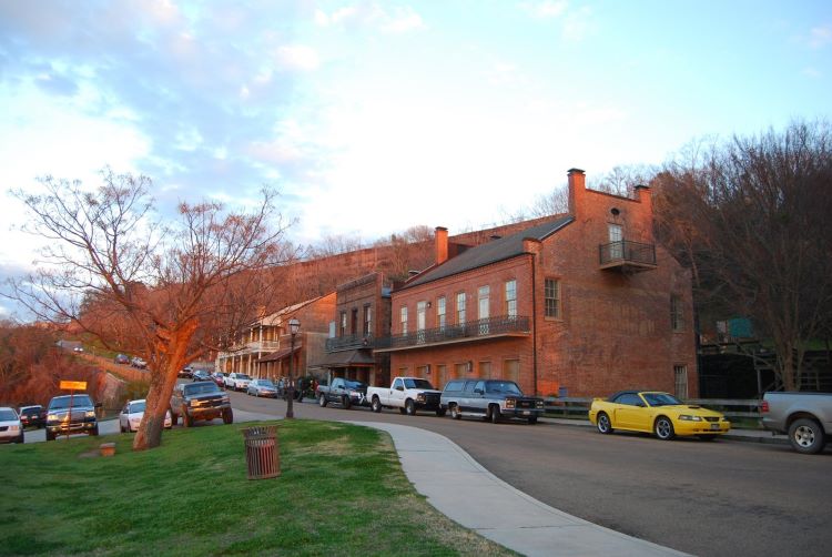 Natchez Under the Hill, once a seedy enclave of vice, is now a great spot for a stroll. A few retail establishments welcome cruise guests. Photo courtesy of Visit Natchez., 