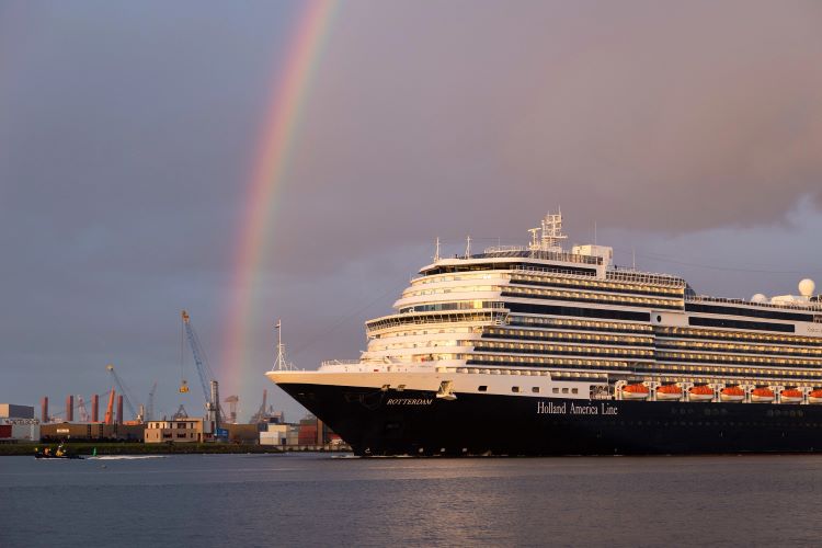 Holland America's new flagship, Rotterdam, is shown under a rainbow at the Port of Rotterdam, The Netherlands. The cruise line now offers many deals with Black Friday savings. Photo by Holland America LIne.