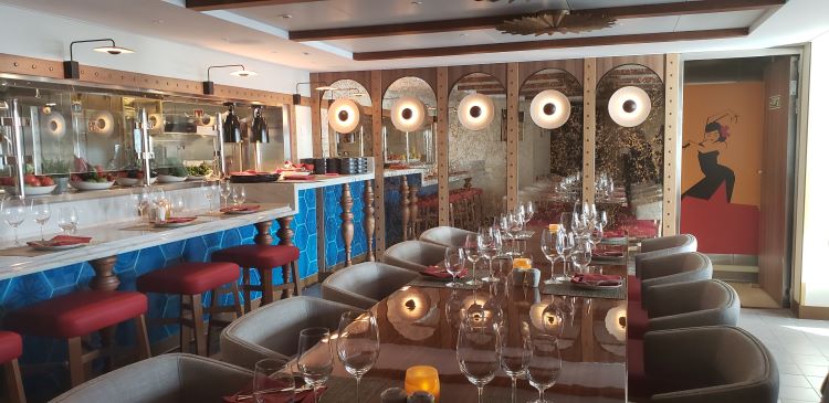 The intimate Cuadro 44, a Spanish small-plates specialty restaurant by famed Chef Anthony Sasso. Shown above is the long communal table (two and four tops are also available in an adjacent area) and the dining bar with galley views. Photo by Susan J. Young