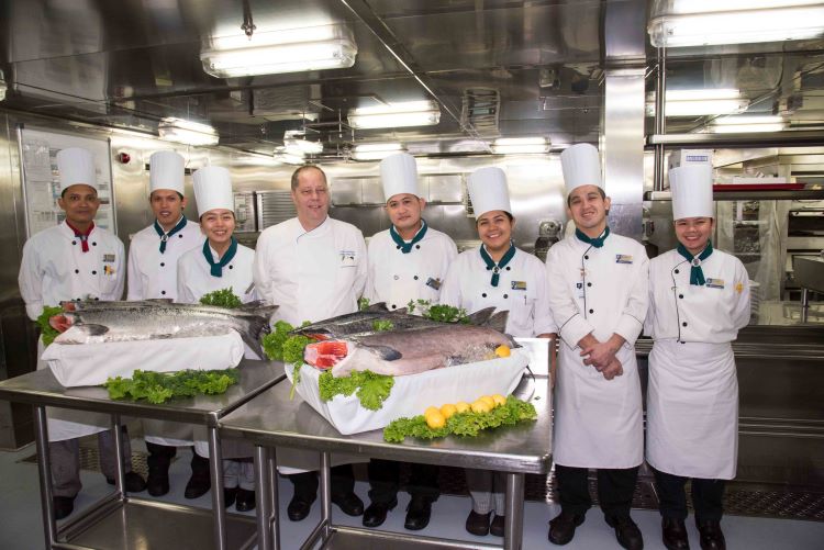 These Holland America chefs prepared fresh Alaska seafood and fish for guests on every Alaska cruise. Photo by Holland America Line.