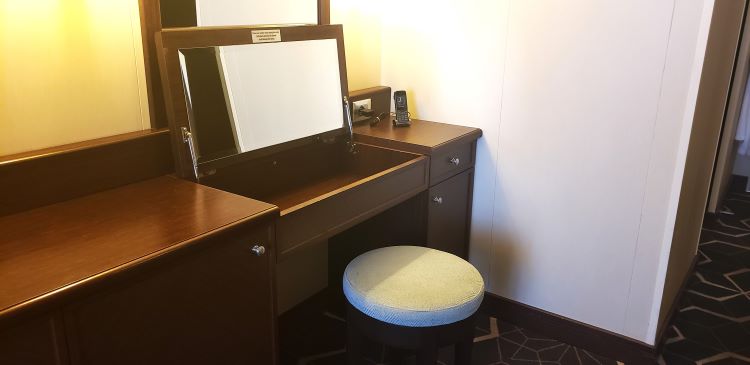 Oceania Marina Penthouse Suite's credenza area that pops up into a make-up mirror with storage drawer. Photo by Susan J. Young