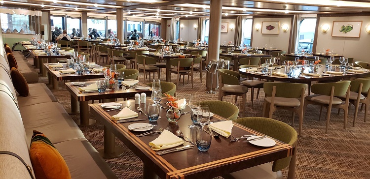 For solo cruise travelers, Seabourn Venture's Colonnade, the casual buffet restaurant, offers some tables for one or two with table service at dinner. Photo by Susan J. Young.