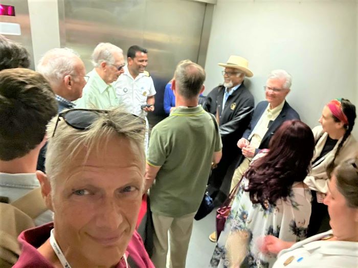 Peter Knego, maritime expert and cruise journalist, is shown in the foreground. At the wall on the right are Ted Lange and Fred Grandy. Photo by Peter Knego.