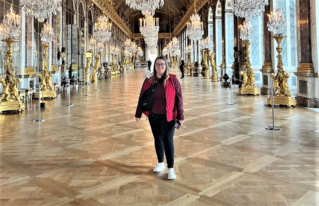 One favorite destination of travel advisor Lee Alvarez of Pavlus Travel is Paris; here's she shown at nearby Versailles. Photo by Lee Alvarez.