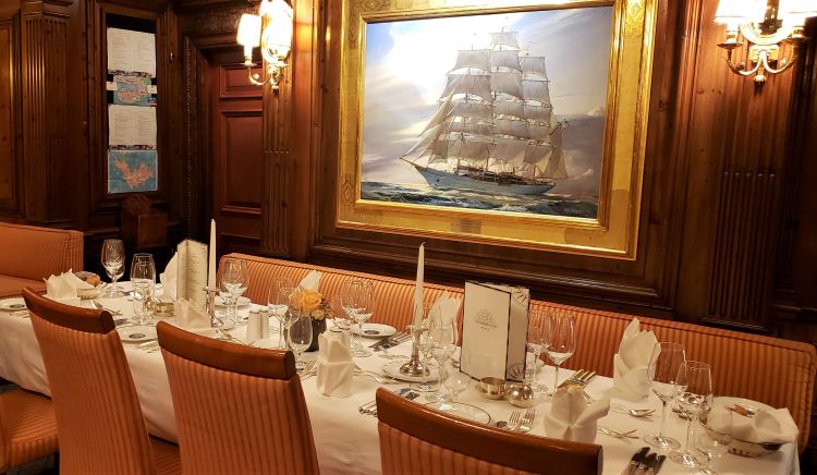 The lovely dining room on Sea Cloud has a painting donated by actress Dina Merrill of the ship; her parents, Marjorie Merriweather Post and E. F. Hutton had the ship built as their personal yacht in the 1930s.