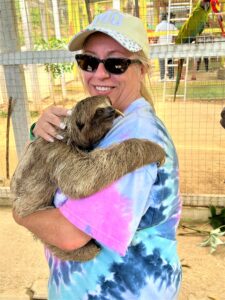 Shari Bazzoni enjoys a close encounter with a sloth. Photo by Shari Bazzoni. 