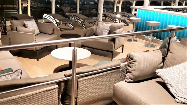 Comfortable seating area and bar on Silver Nova's pool deck. Photo by Susan J. Young.
