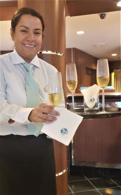Upon arrival on Crystal Serenity, The Meandering Traveler was greeted by a smiling, friendly crew member serving an excellent bubbly. Photo by Susan J. Young.