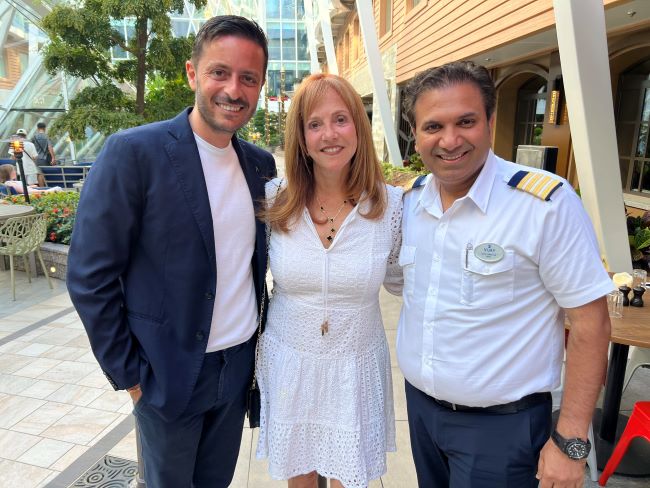 Vicki Freed of Royal Caribbean is shown aboard Symphony of the Seas with the ship's F&B director and hotel director. Photo by Royal Caribbean International.