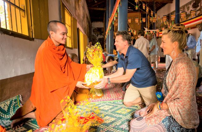 A&K guests with a monk in Siem Reap/Angkor, Cambodia. Photo copyright 2015 Abercrombie & Kent.