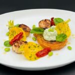 A new dish at Solis is roasted scallops with toasted brioche, spinach, ricotta, broad beans and crisp, yellow beet roots. Photo by Seabourn.