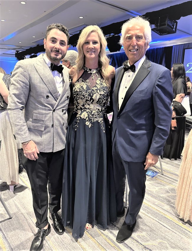 Shown at a travel industry event are, left to right, Anthony Rich of Uniworld with Shelby Steudle and Craig Pavlus of Pavlus Travel. Photo by Pavlus Travel. 