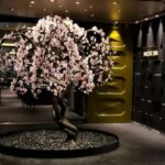 Pacific Rim specialty dining venue on Regent Seven Seas Cruises new Seven Seas Grandeur. Cherry blossom tree art piece at the restaurant's entrance is shown above. Photo by Susan J. Young.