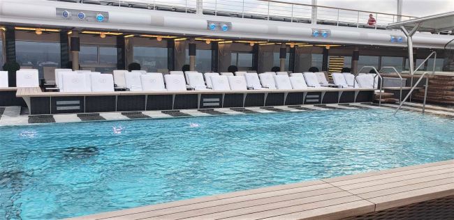 Pool and comfortable lounge chairs on Regent Seven Seas Cruises new Seven Seas Grandeur. Photo by Susan J. Young. 