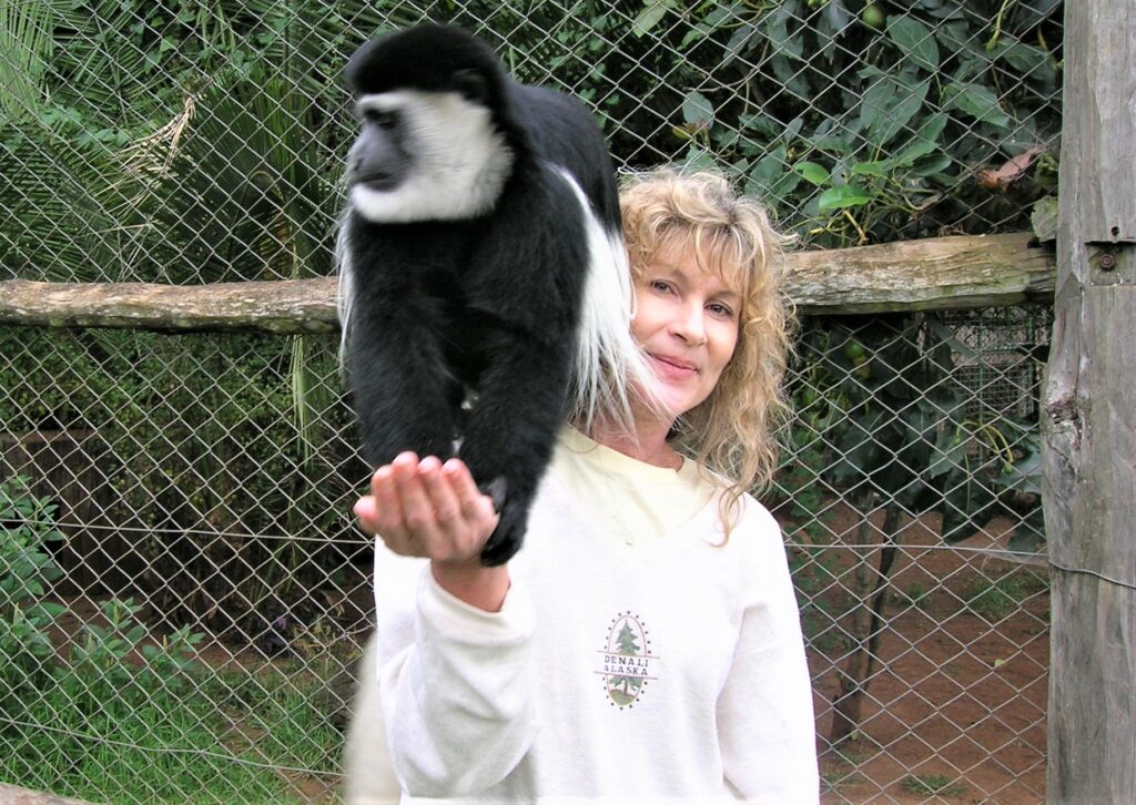 On a past trip, Susan Bender had the chance to hold a monkey at a Kenya wildlife rescue center. Photo by Susan Bender.