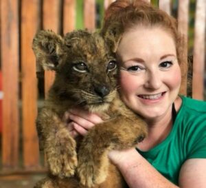 Fia Bauer holds a lion cub at an East Africa rescue center. Photo by Fia Bauer.