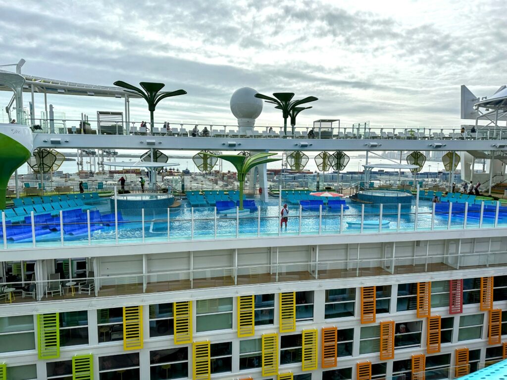 Looking out from one side of Icon of the Seas, Central Park with its accommodations is seen below, and one of the many pool areas on the other side. Photo by Shelby Steudle.