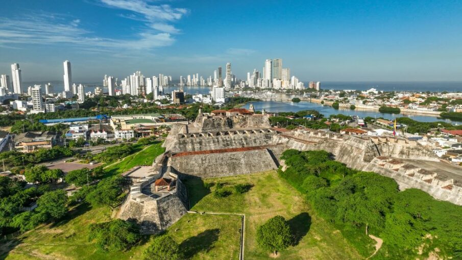 Modern Cartagena, Colombia is shown in the backgroun, and the Spanish-era fortress in the foreground. Photo by PROCOLOMBIA.