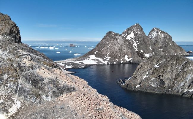 Viking's expedition team supported the discovery of a new colony of chinstrap penguins not previously known to science on Diaz Rock, near Astrolabe Island, in Antarctica. Pictured here, Astrolabe Island with Diaz Rock in the distance. Photo credit Hayley Charleton-Howard. 