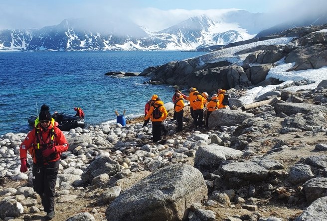 A Seabourn Venture expedition team member leads guests on a hike ashore. Photo by Erin Conner.