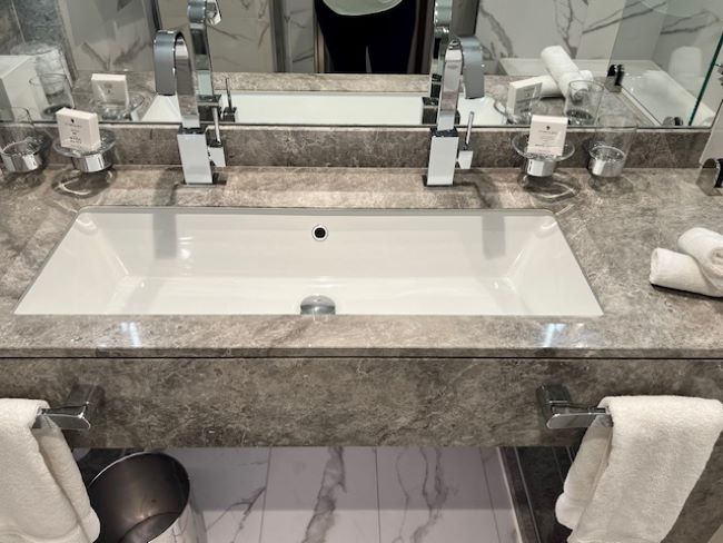 A long elongated sink on the bathroom vanity has two separate faucets -- so two people can get ready at the same time. Photo by Erin Conner.