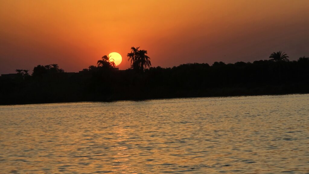 The sun sets over the Nile River, as viewed from our Viking Sobek balcony cabin. Photo by Susan J. Young. 