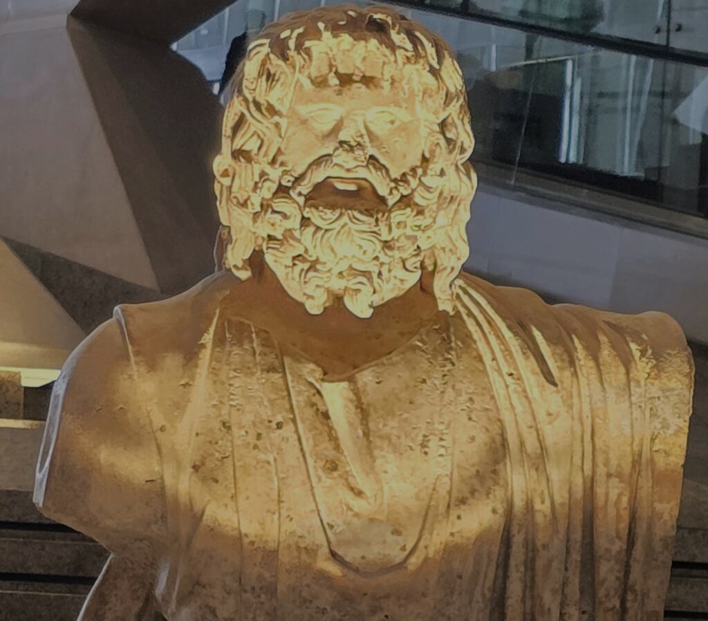 One ancient statue displayed along the Grand Staircase in the new Grand Egyptian Museum. Photo by Susan J. Young. 