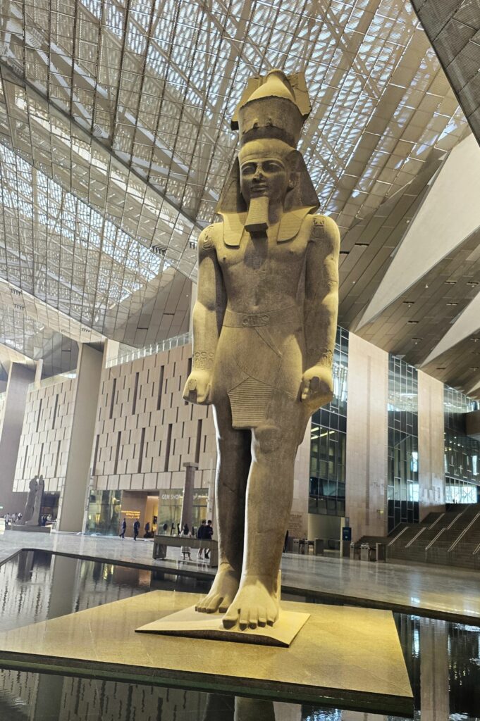 Massive ancient statue of Ramses II greets visitors to the new Grand Egyptian Museum (GEM) on the Giza Plateau in Egypt. Photo by Susan J. Young. 