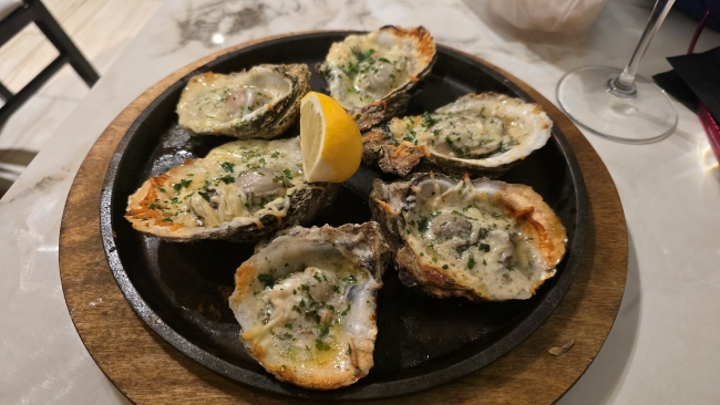 Baked oysters savored during a pre-cruise stay in New Orleans, LA. Photo by Susan J. Young.