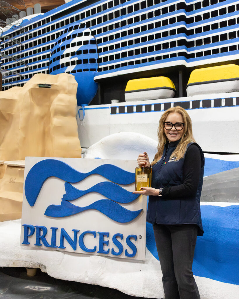 Jill Whelan, Princess' celebration ambassador and former star of The Love Boat TV show, christens Princess' 2026 Tournament of Roses Parade float. Photo by Princess Cruises. 