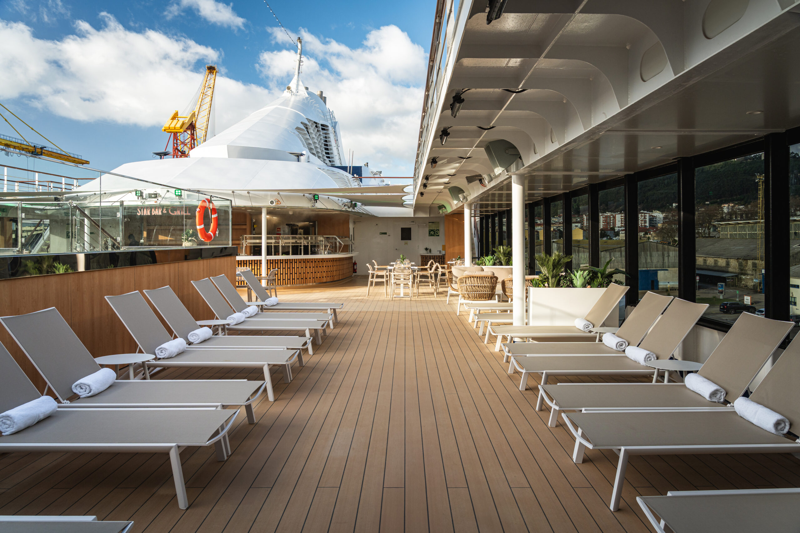 Star Seeker's pool deck with loungers and the StarBar & Grill in the background. Photo by Windstar Cruises. 