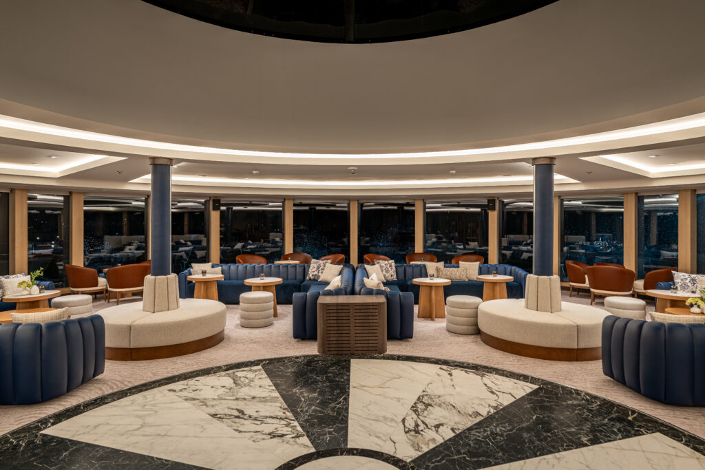 The new Star Seeker's Yacht Club has attractive design, plenty of comfortable seating areas and large expanses of glass -- both in viewing windows to outside and an upper skylight dome. Photo by Windstar Cruises.